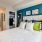 well lit bedroom with closet and bathroom access