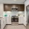 c-shaped kitchen that's well lit and looks across living room